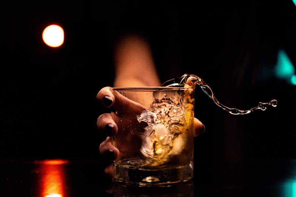 Alcohol pouring out of a glass - Which Rehab