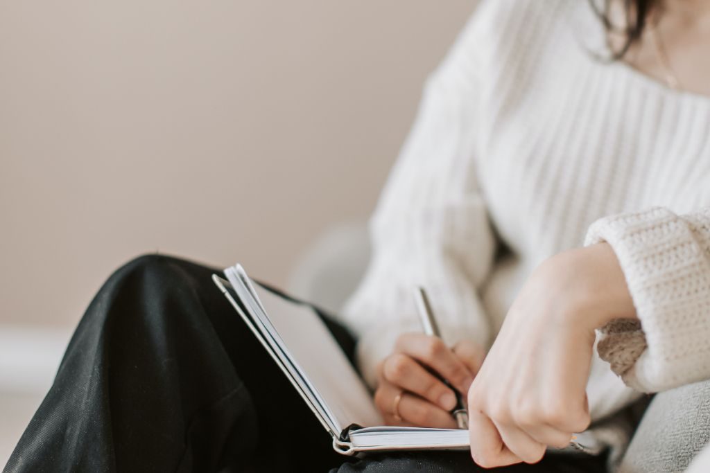Woman writing in a journal - Which Rehab