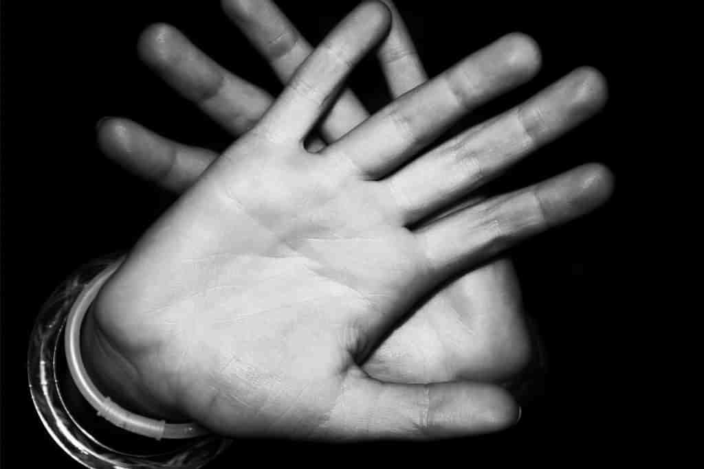 A pair of hands being held up to block the camera - Which Rehab