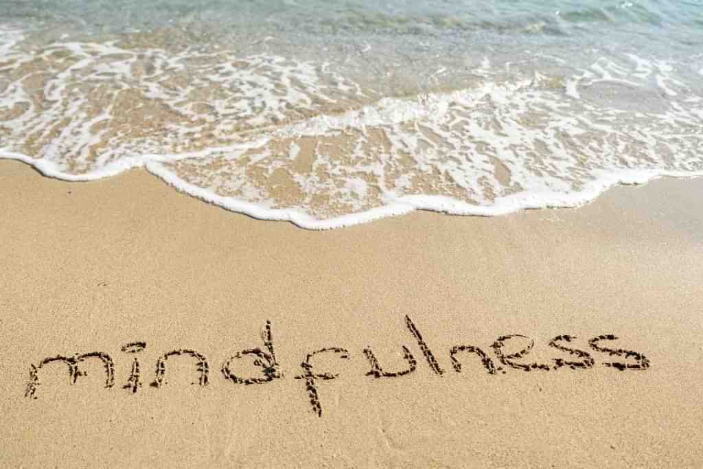 A beach with the word 'mindfulness' written in the sand - Which Rehab